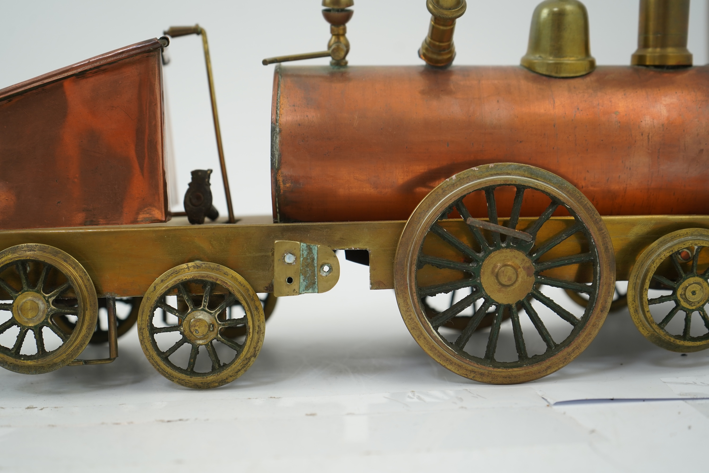 Three late 19th or early 20th century brass and copper live steam locomotives; a 2-2-4, ‘Monarch’, gauged to run on approximately 4 1/2 inch track, 33cm long frames, a 2-2-2, ‘Dragon’, gauged to run on approximately 3 1/